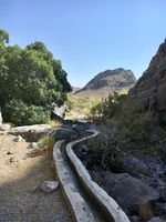 Falaj leading water through the wadi and down to the village
